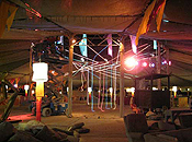 A scissor-lift is used to fix lighting to the ceiling of Center Camp.