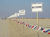 A row of signs, like Burma Shave billboards of yore, line the entrance road to Black Rock City.