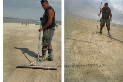 man using a large landscape rake to rake the playa