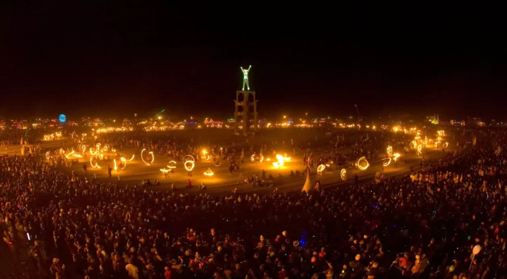 Fire dancers around the Man