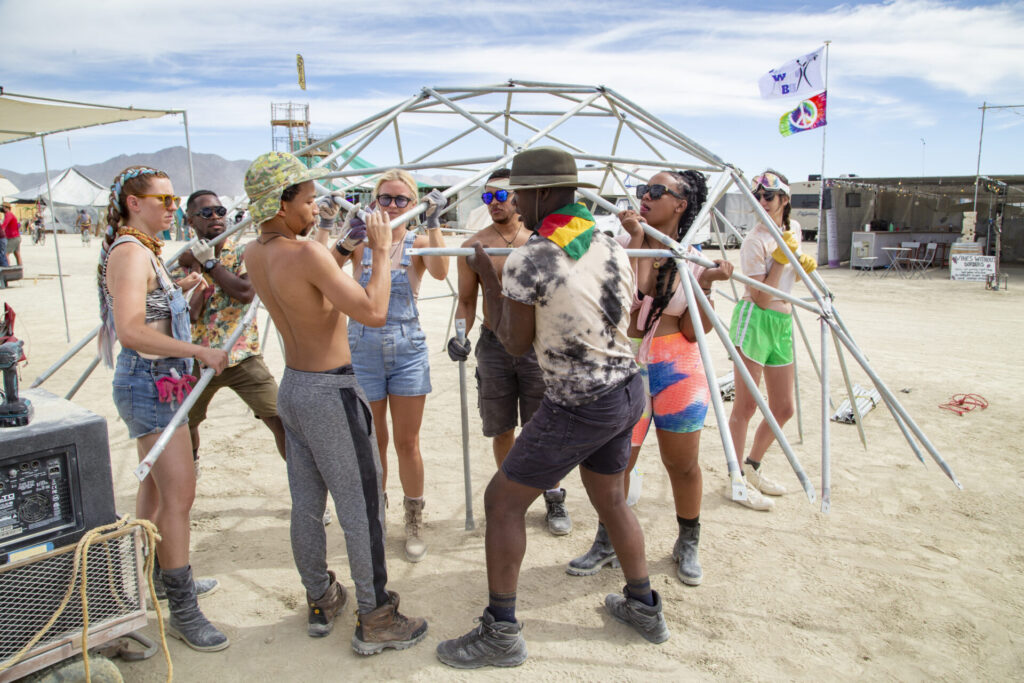 Campers working together to build a dome at Burning Man
