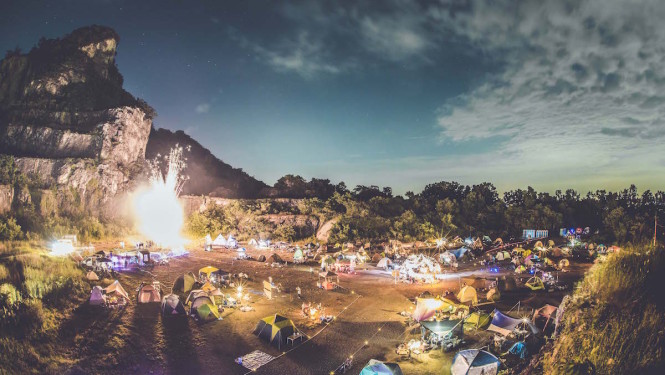 A campout at sunset with trees in the background