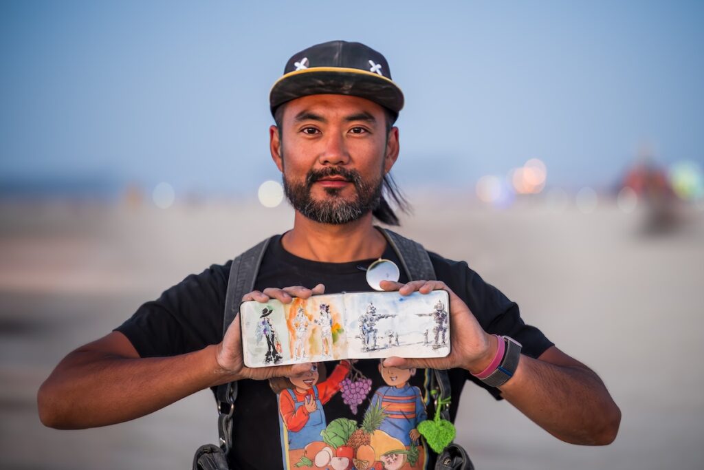 Edi Hsu displays his sketchbook where he captures quick drawings of scenes as they unfold.