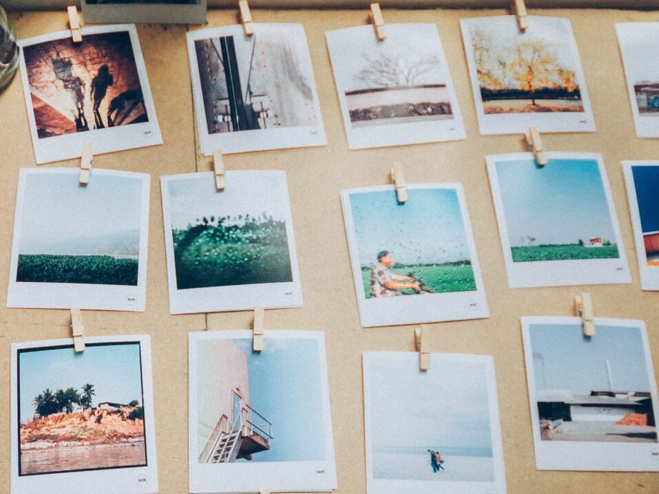 Polaroid photos pinned to a board