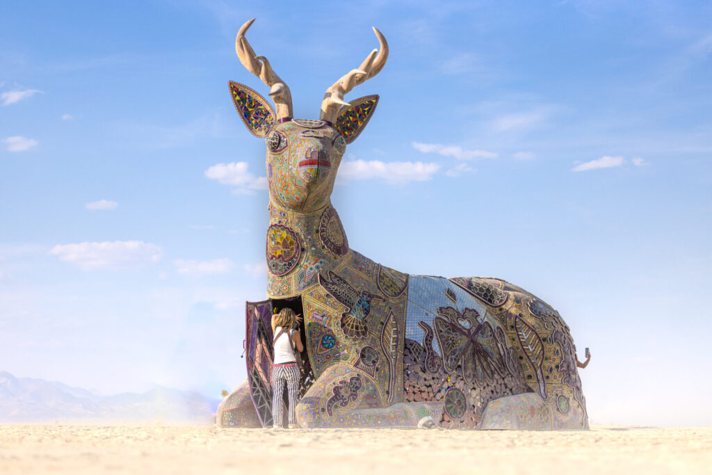 An antelope-shaped building with intricate detailed figures on the walls