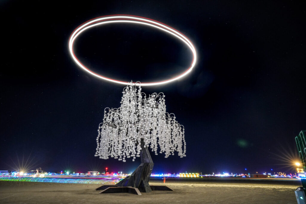A tree made of white lights and a large glowing halo above it