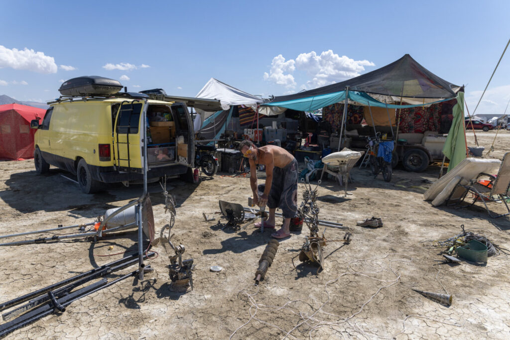Participant setting up camp infrastructure.