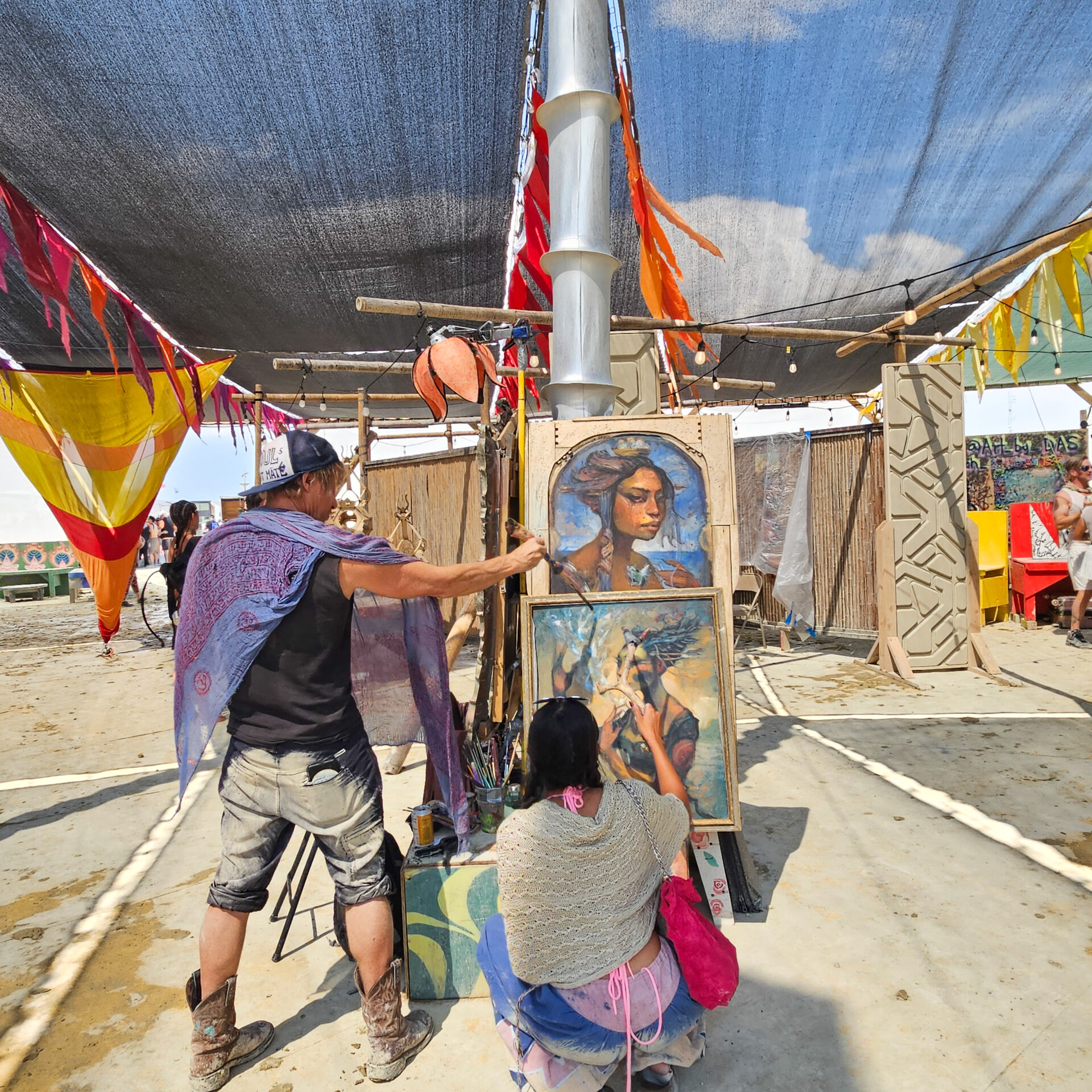 People paint on canvas in Center Camp
