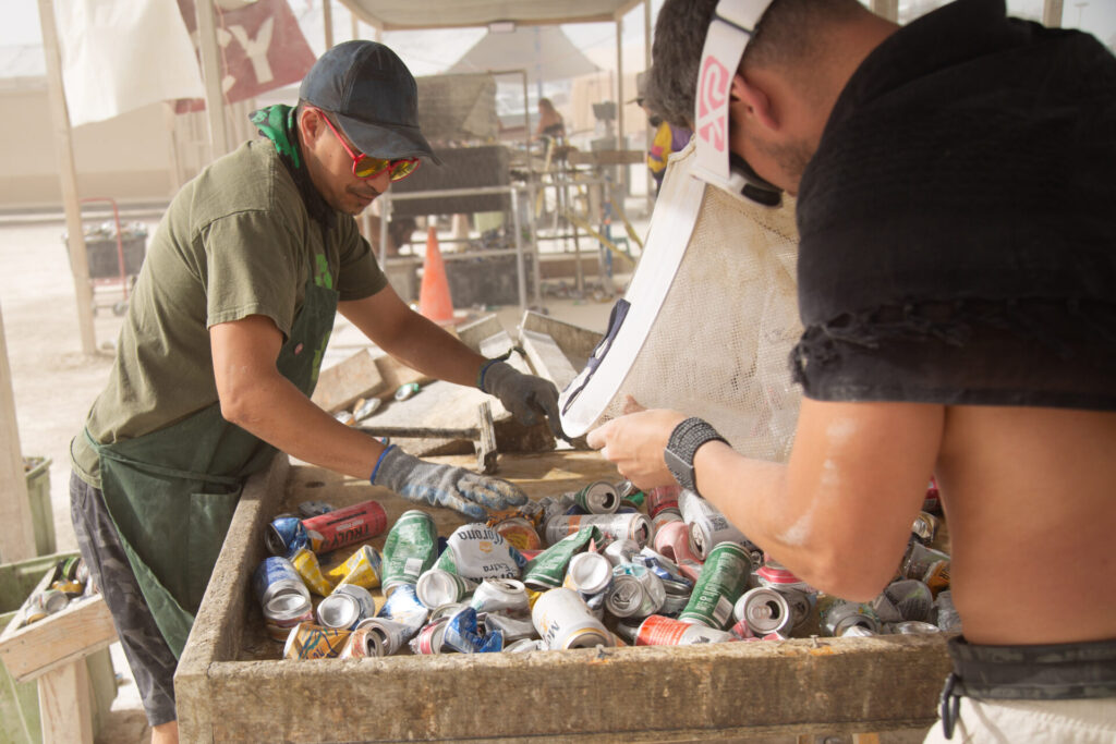 Volunteers at recycle camp sorting cans