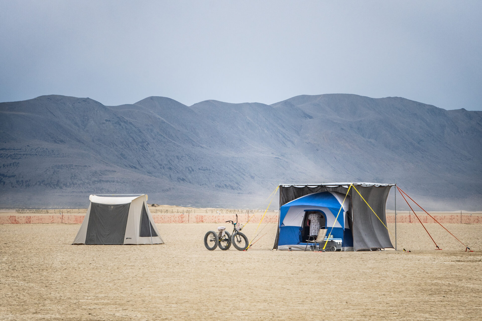 Two tents and a bicycle in open camping