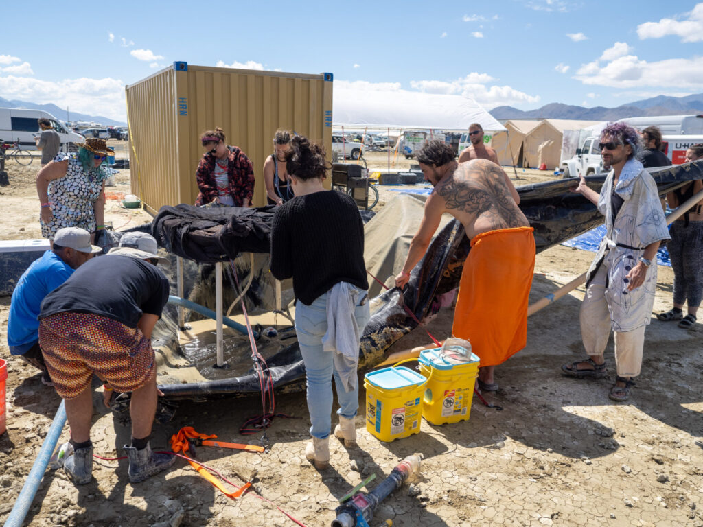 Campers working on a grey water disposal system.