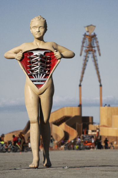 A sculptural figure of a humanoid pulling back the "skin" of it's chest to reveal mechanical ribs.