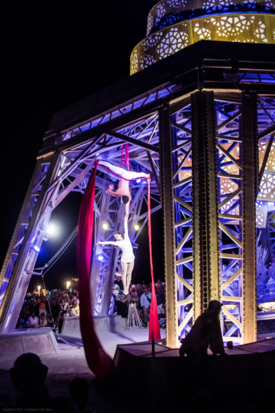 Aerialists perform in the man base at night