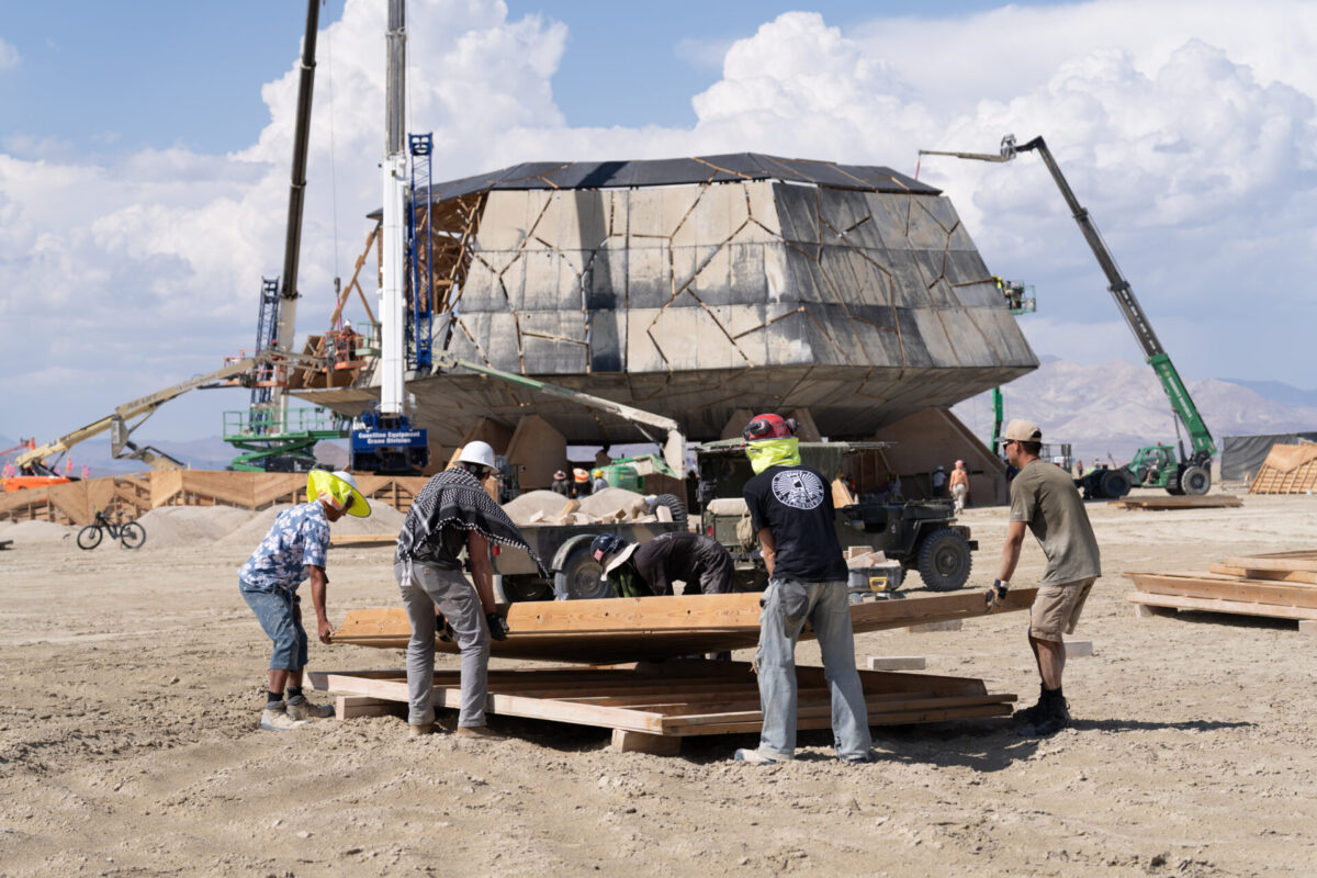Volunteers unload panels for constructing Temple of the Deep