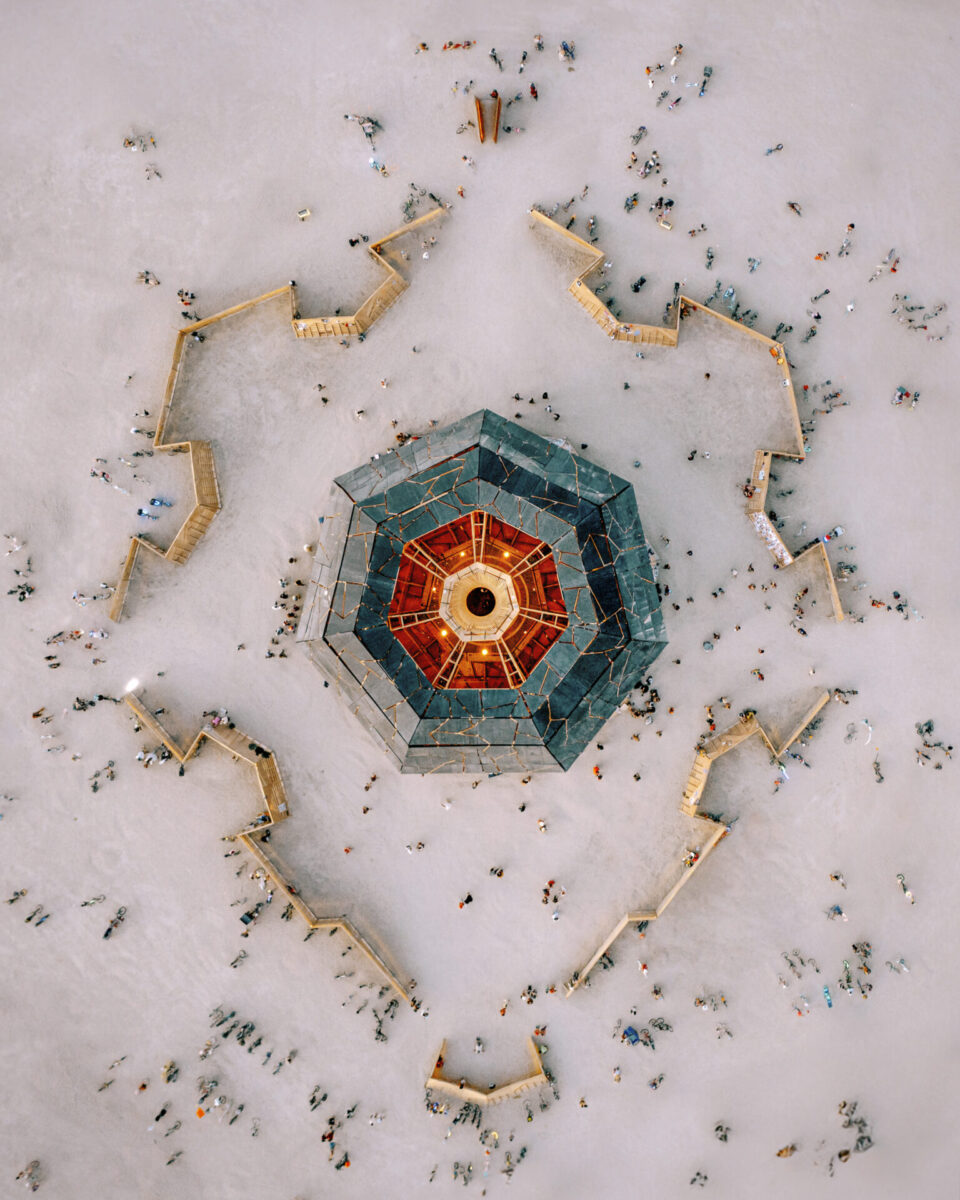 Aerial view of a seven-sided structure with yellow, red and green roof