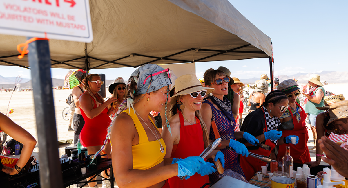 Members of 'Playa Weenies' camp offer hot dogs and cold drinks to appreciative passersby.