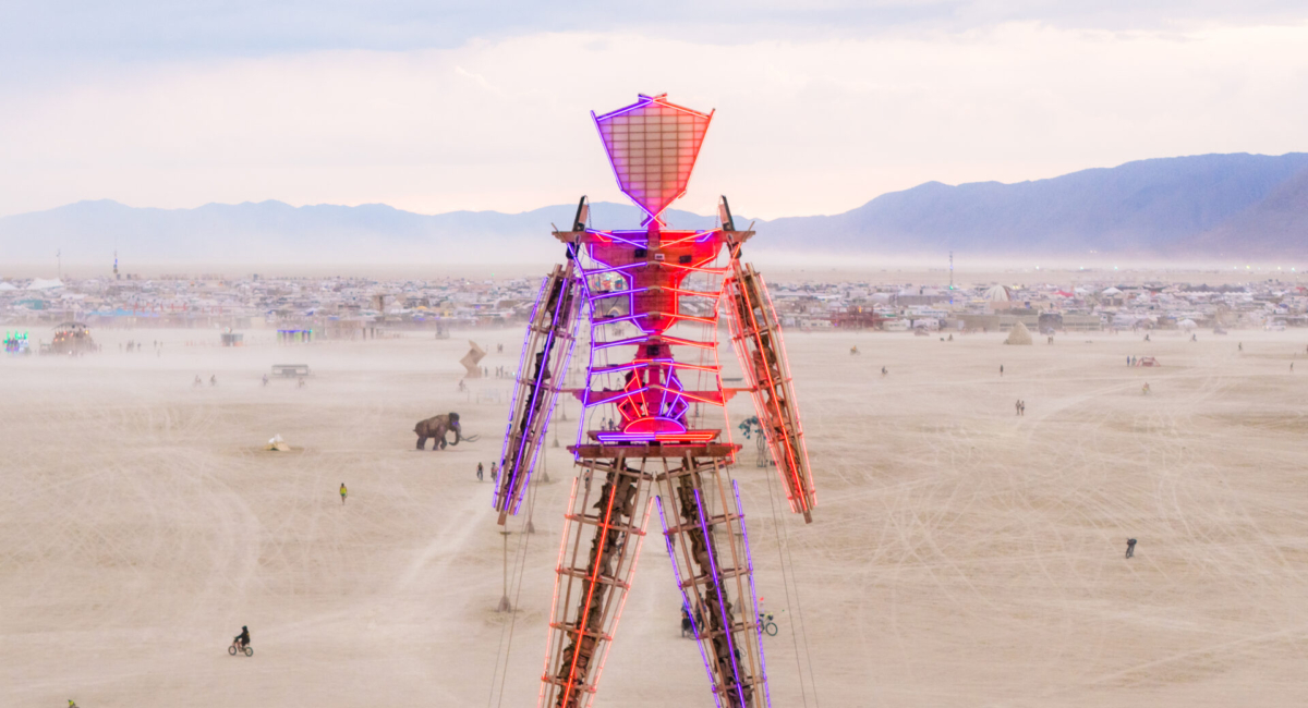 Drone shot of the neon Man over Black Rock City, 2025 (Photo by Jamen Percy)