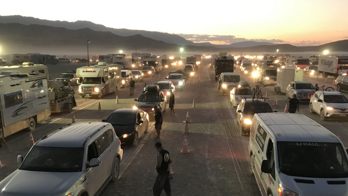 Rows of cars, trucks, RVs and trailers in gate road waiting to get into Black Rock City.