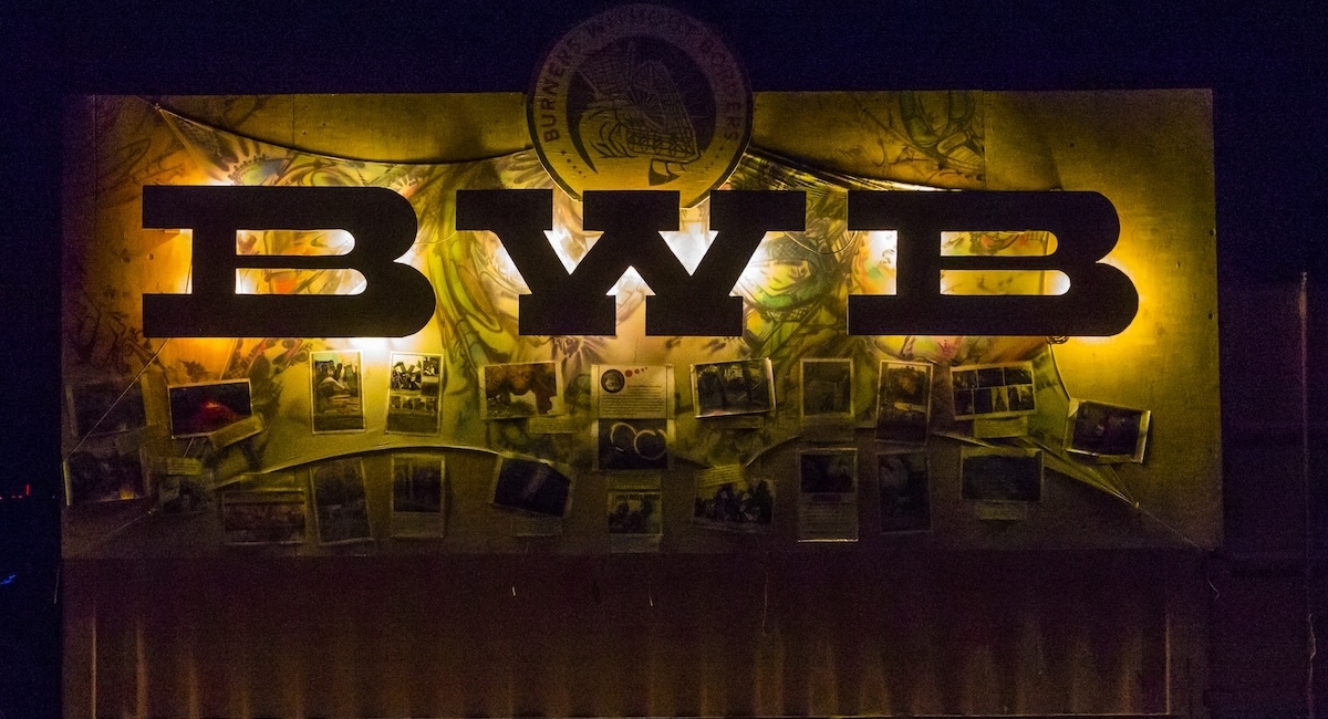 BWB letters backlit over a banner celebrating Burners Without Borders