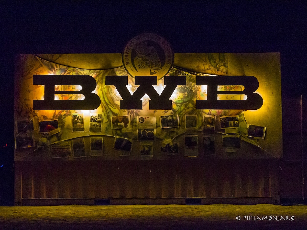 BWB letters backlit over a banner celebrating Burners Without Borders