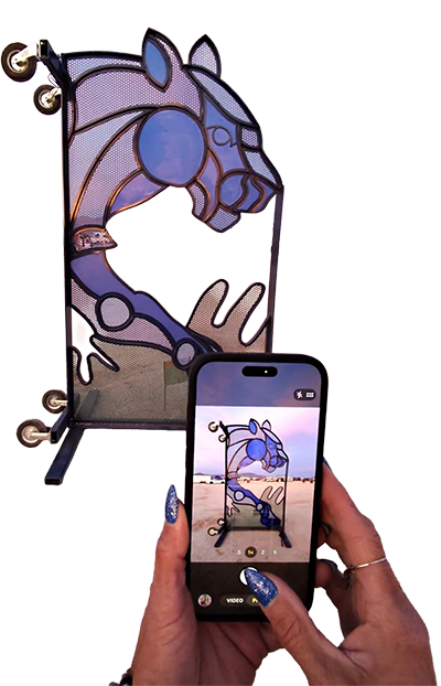 A cart turned on its side turned into a frame for stained glass style purple big cat head.