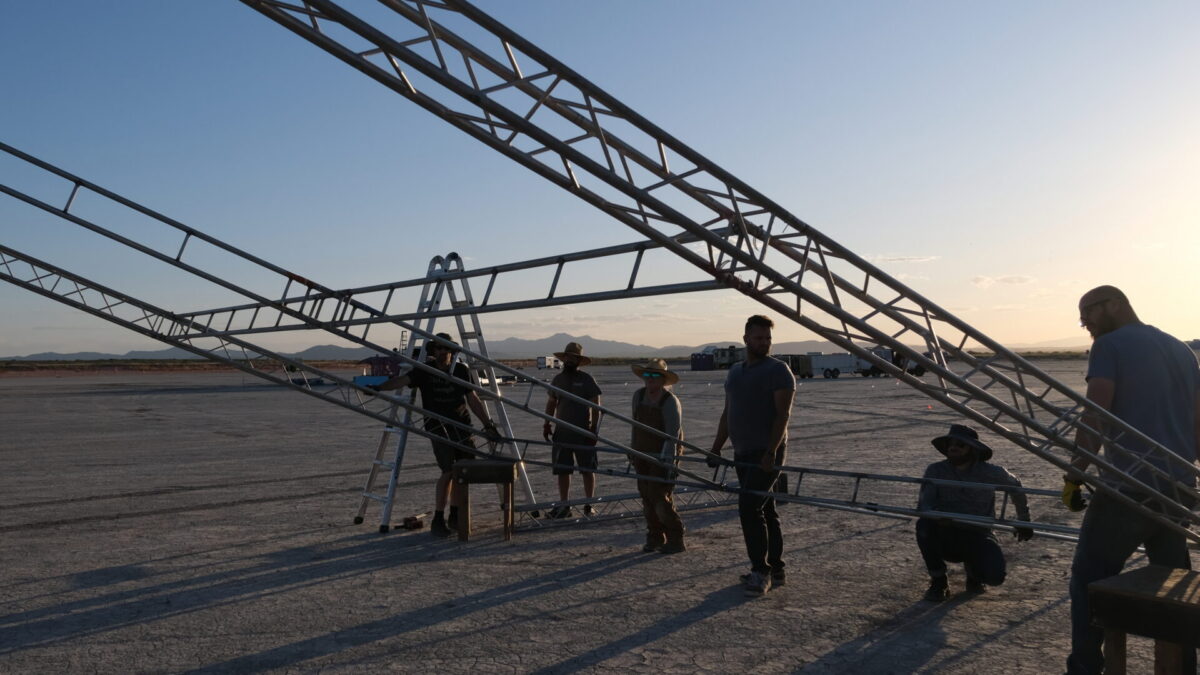 A group of people set up trusses