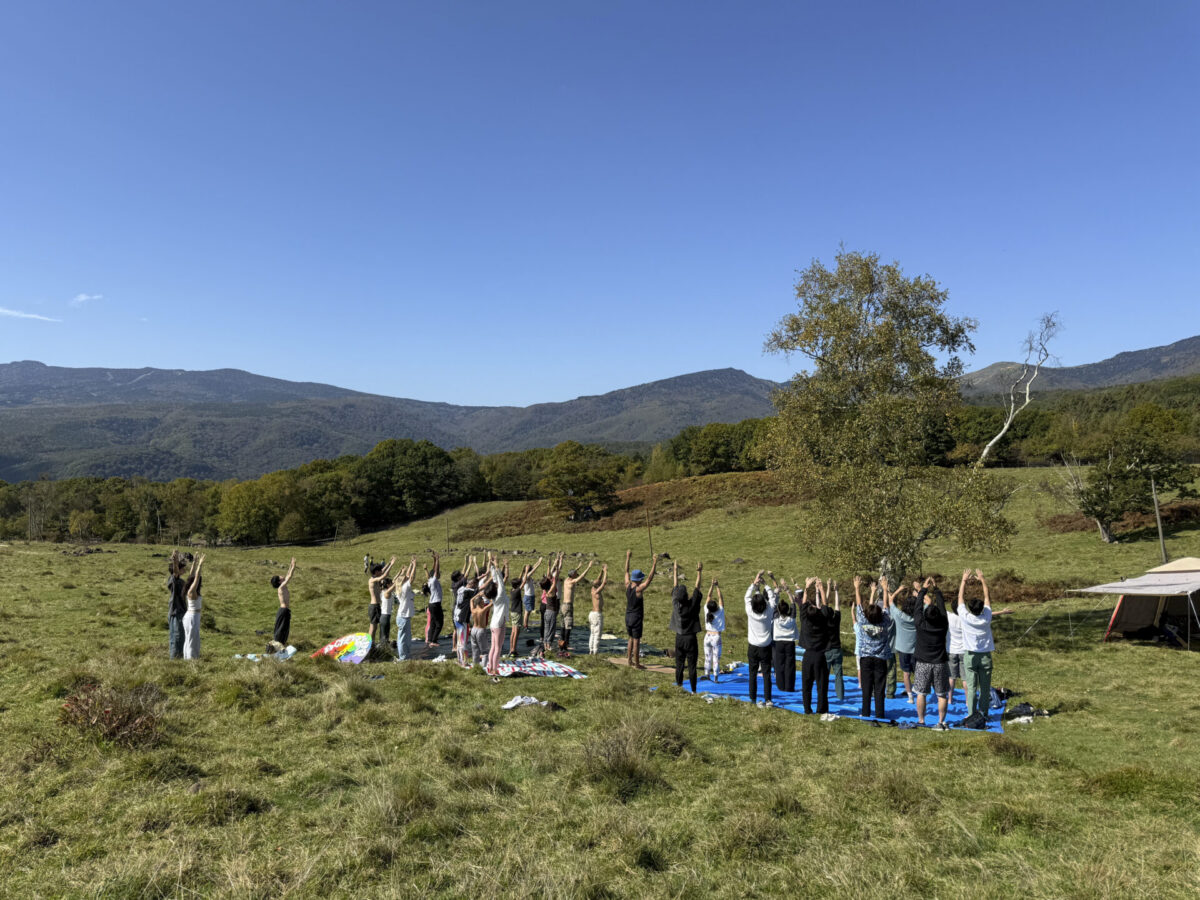 Yoga workshop on a grassy hillside