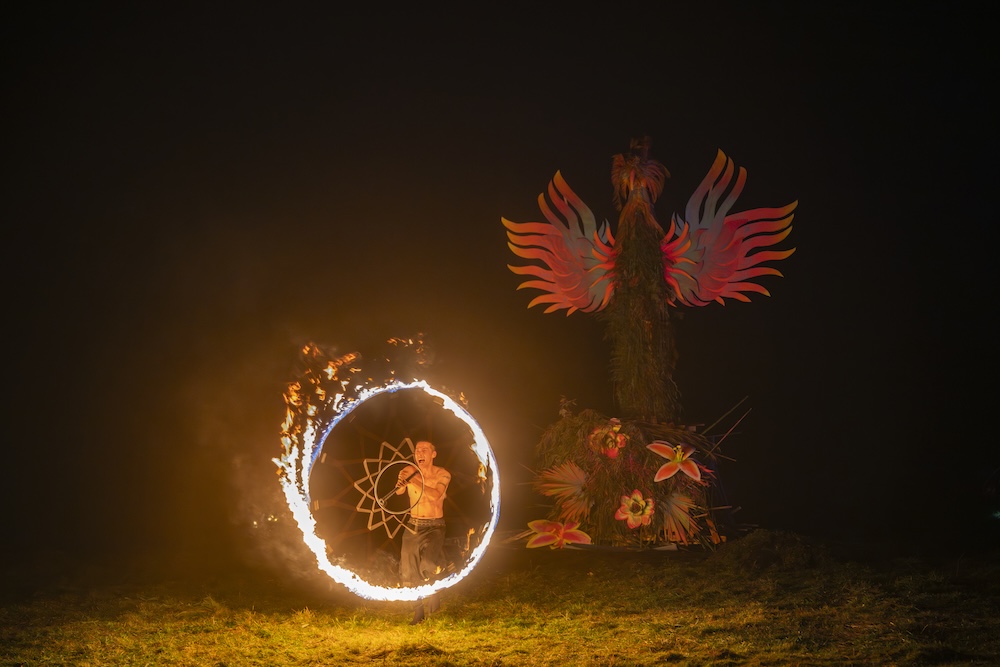 A person spins a fiery ring of sparks 