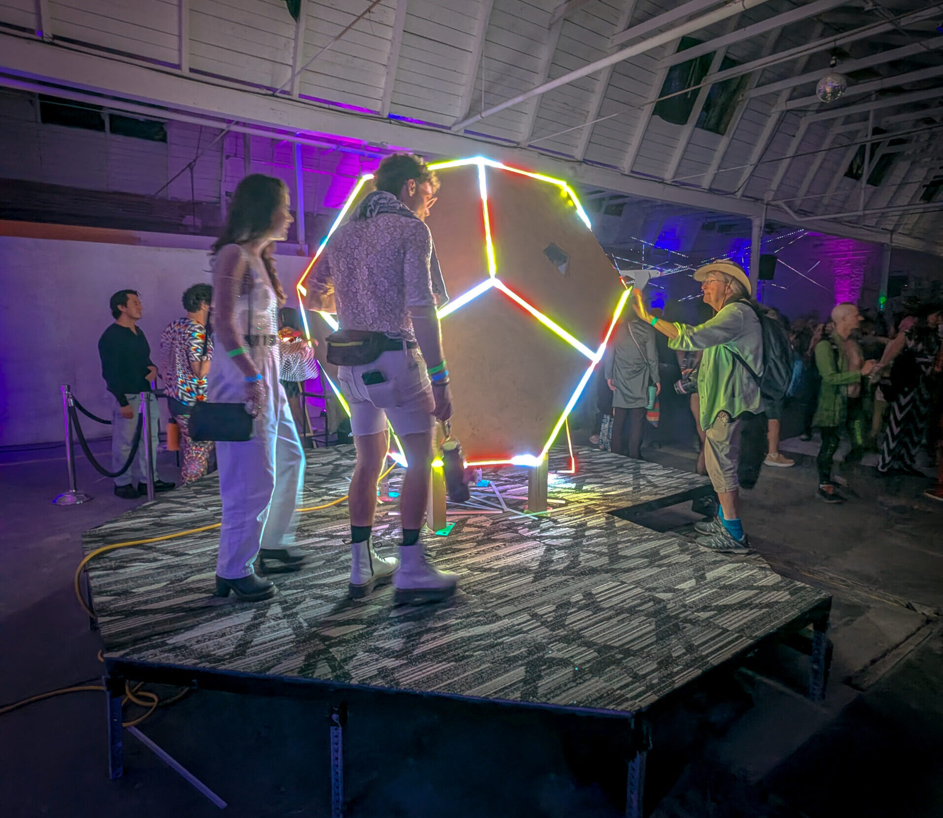 People examining the kaleidoscope at Decompression Oakland