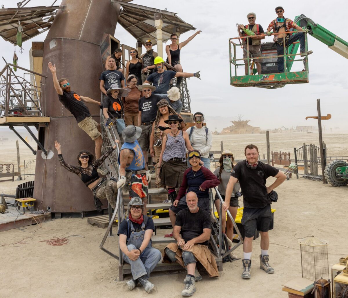 Build team members stand around and on the Over and Below sculpture in BRC.